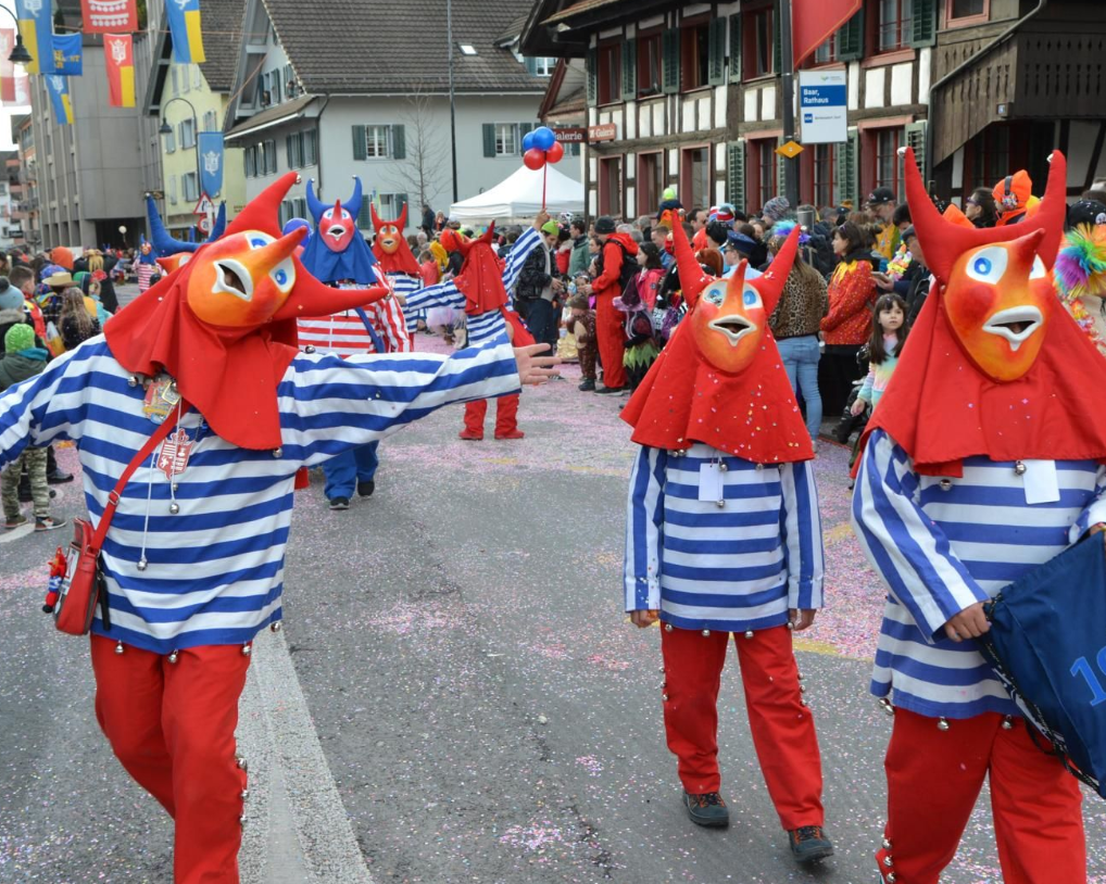 Three masked carnival revellers at the parade in Baar.